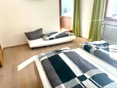 Ein Bett oder Betten in einem Zimmer der Unterkunft Pension Sonnegg