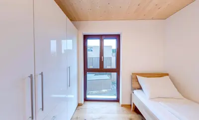 Ein Bett oder Betten in einem Zimmer der Unterkunft Urban-Apartmenthaus zwischen Berg und See