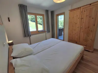 Ein Bett oder Betten in einem Zimmer der Unterkunft Ferienwohnung Almrausch by Alpenfeder