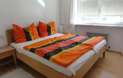 Ein Bett oder Betten in einem Zimmer der Unterkunft Ferienwohnung Wolfurt