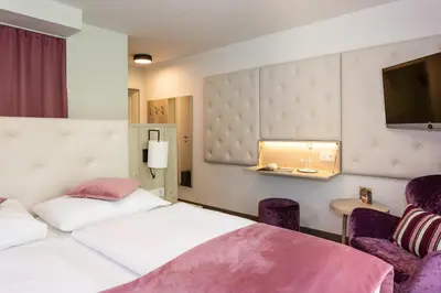 Ein Bett oder Betten in einem Zimmer der Unterkunft Boutiquehotel Bergvilla Am Fuße der Alpen