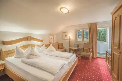 Ein Bett oder Betten in einem Zimmer der Unterkunft Alpenhotel DAS KÜREN