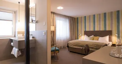 Ein Bett oder Betten in einem Zimmer der Unterkunft Schlosshotel Dörflinger