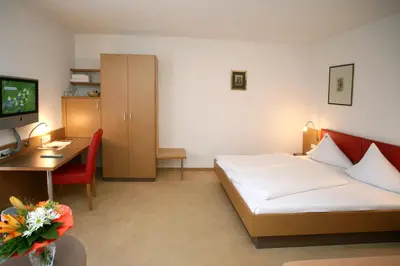 Ein Bett oder Betten in einem Zimmer der Unterkunft Hotel Bischof
