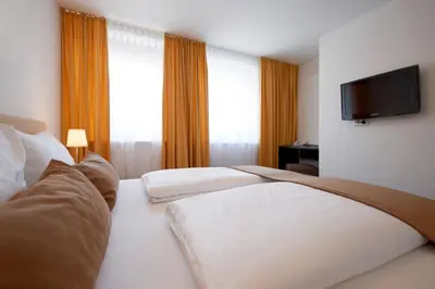 Ein Bett oder Betten in einem Zimmer der Unterkunft Hotel Garni Tannleger B&B