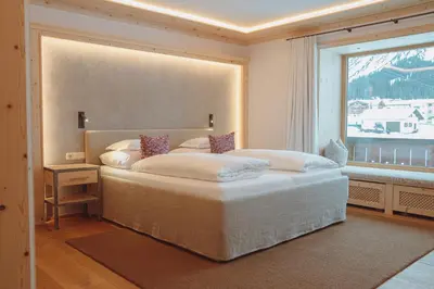 Ein Bett oder Betten in einem Zimmer der Unterkunft Alpenland - das feine Kleine, zentral und ruhig mit modernem Wellnessbereich