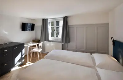 Ein Bett oder Betten in einem Zimmer der Unterkunft Krone Hard - self check-in