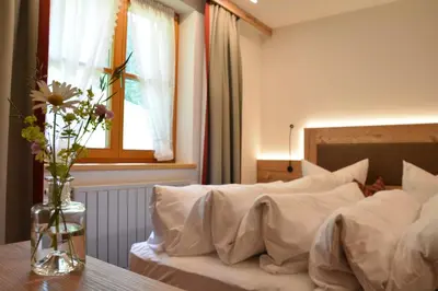 Ein Bett oder Betten in einem Zimmer der Unterkunft Hotel Garni Alpina