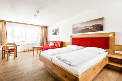 Ein Bett oder Betten in einem Zimmer der Unterkunft Aparthotel Kleinwalsertal