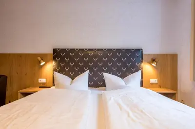 Ein Bett oder Betten in einem Zimmer der Unterkunft Landhaus Almrausch