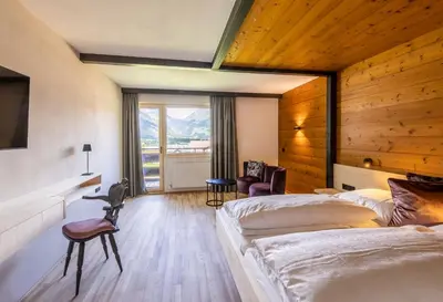 Ein Bett oder Betten in einem Zimmer der Unterkunft BOUTIQUEHOTEL das edelweiss