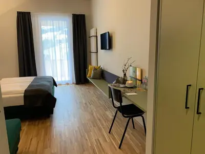 Ein Bett oder Betten in einem Zimmer der Unterkunft JUFA Hotel Laterns - Klangholzhus