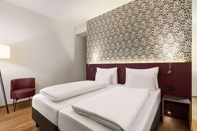 Ein Bett oder Betten in einem Zimmer der Unterkunft Amedia Lustenau, Trademark Collection by Wyndham