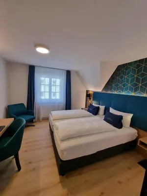 Ein Bett oder Betten in einem Zimmer der Unterkunft Hotel Messmer