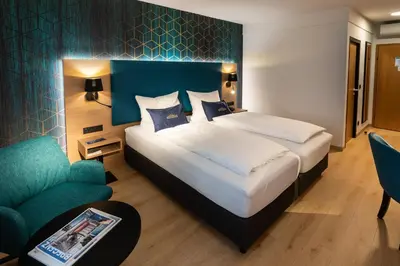 Ein Bett oder Betten in einem Zimmer der Unterkunft Hotel Messmer